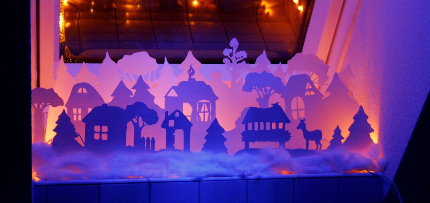 Winter village on the windowsill in the technique of kirigami