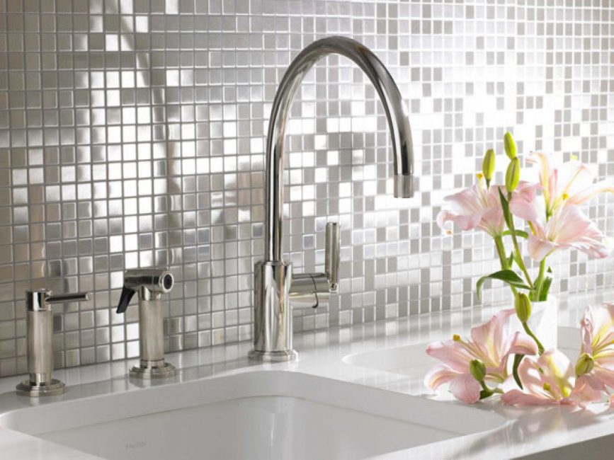 Mother of pearl pieces of tiles shimmer with colors of the rainbow and decorate the kitchen