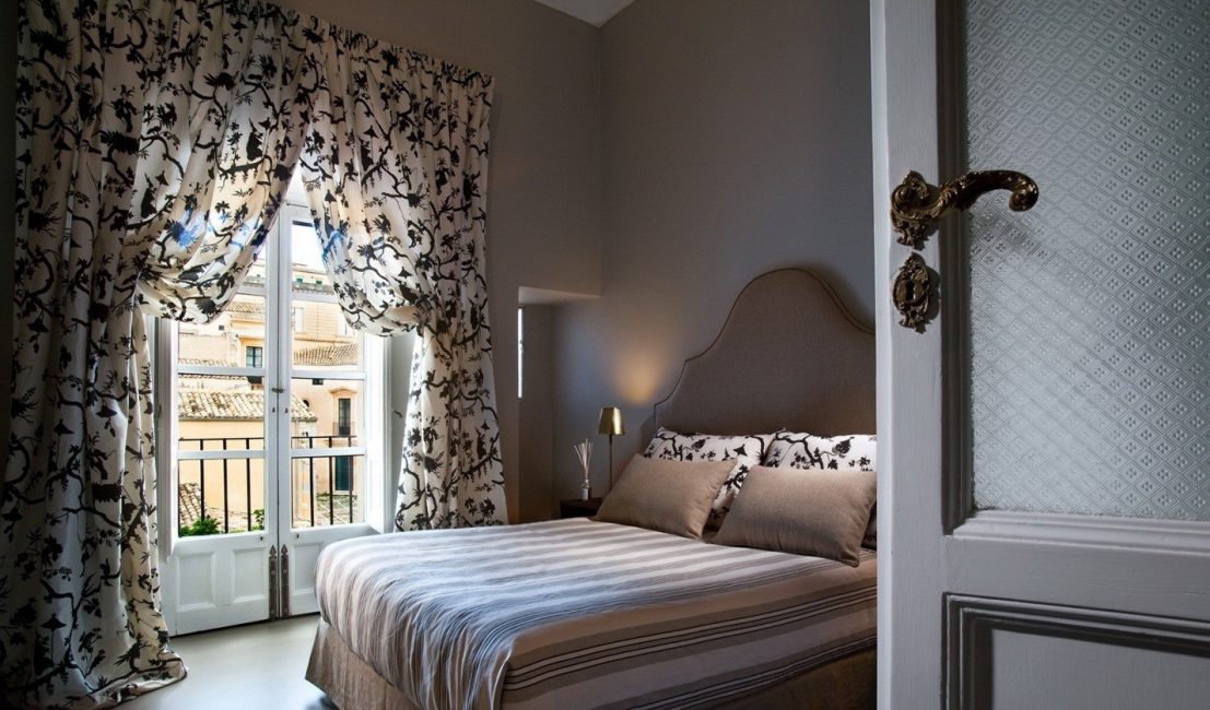 Yatak odası için perdeler dekoratif bir rol oynamaktadır